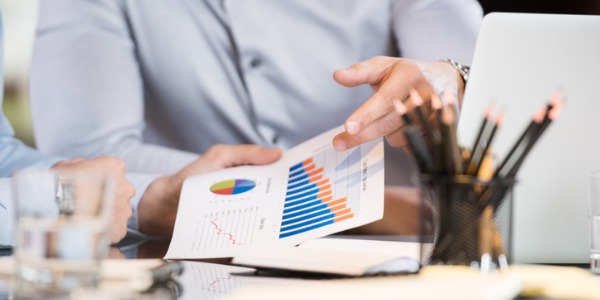 A budget analyst showing a client a review of financial information and a budget proposal.