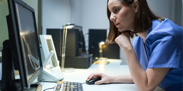 A public health nurse looking at her computer.