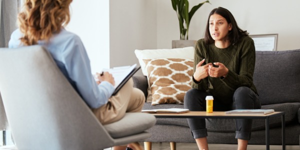 A psychiatrist sitting across from a patient.