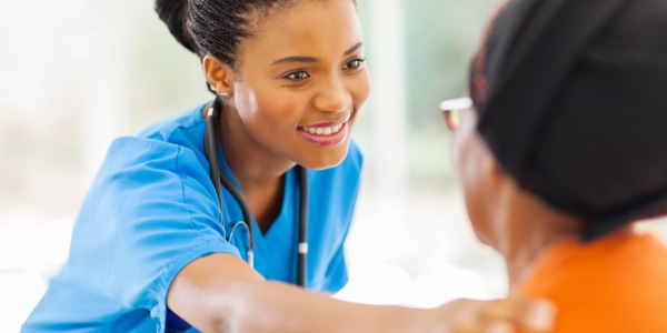 A clinical nurse specialist interacting with a patient.