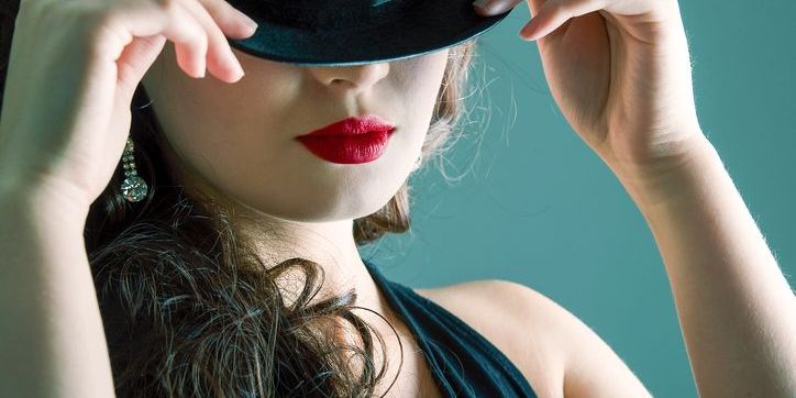 A cabaret performer holding a bowler hat.