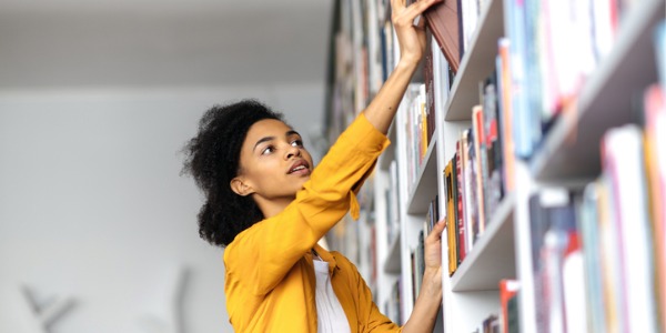 A library assistant putting books away.