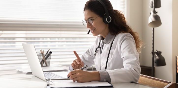 A telemedicine physician talking to a patient on the computer.
