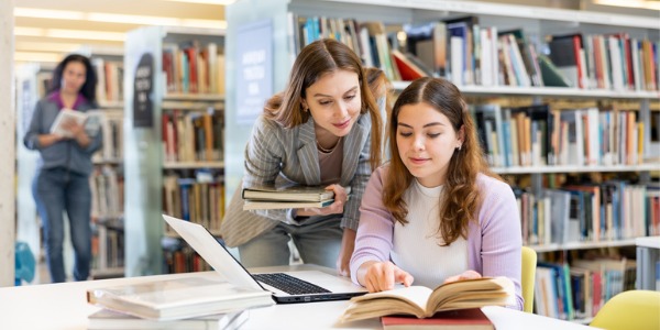 A community librarian helping a patron.