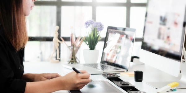 A multimedia animator creates animation on her computer.