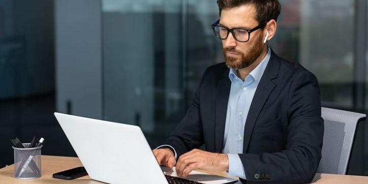 An E-commerce data scientist working on his computer.