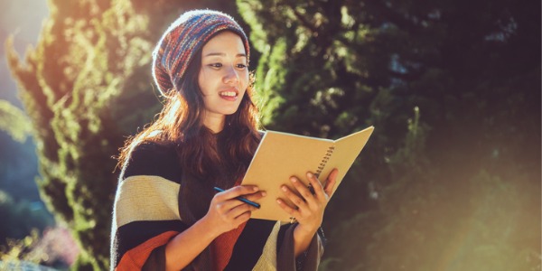 A poet reading poetry out loud outdoors.