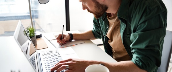 A sports writer working on his computer.