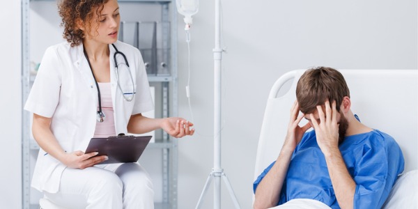 A psychiatric nurse talking to a distraught patient.