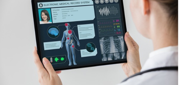 An informatics nurse specialist looking at an electronic medical record.