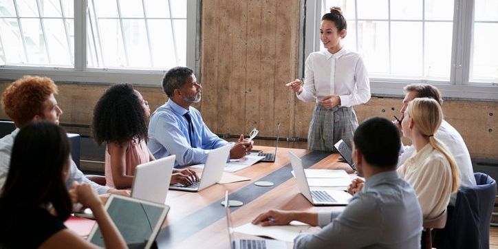 A customer experience manager having a meeting with an internal team.