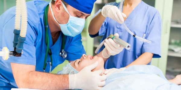 A nurse anesthetist administering anesthesia in the operating room.