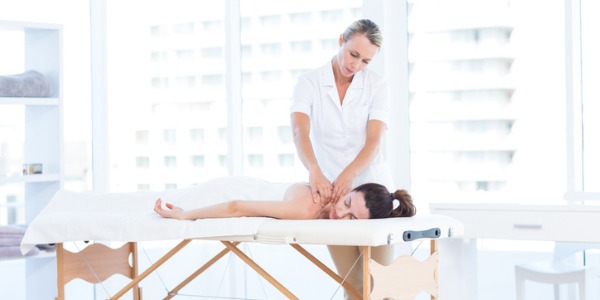 A massage therapist giving a massage therapy treatment to a client.